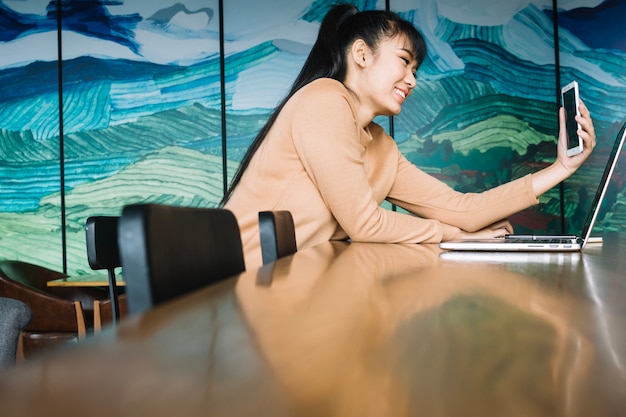 Mädchen macht Selfie am Arbeitsplatz