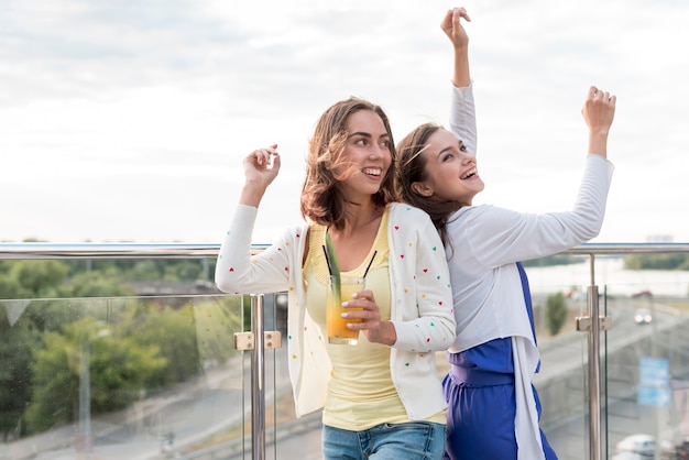 Mädchen tanzen Rücken an Rücken auf einer Party