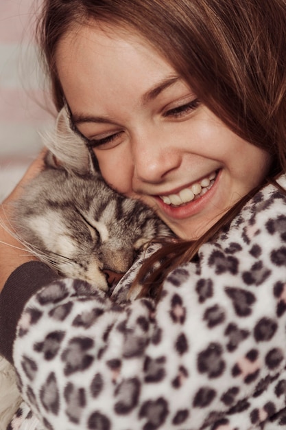 Mädchen und Katze sind glücklich und lieblich