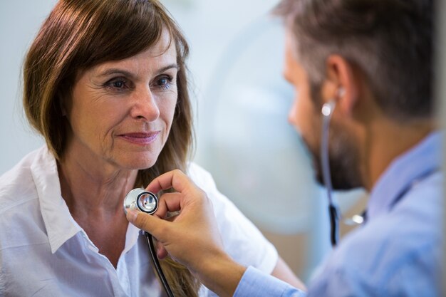 Männliche Arzt einen Patienten untersucht