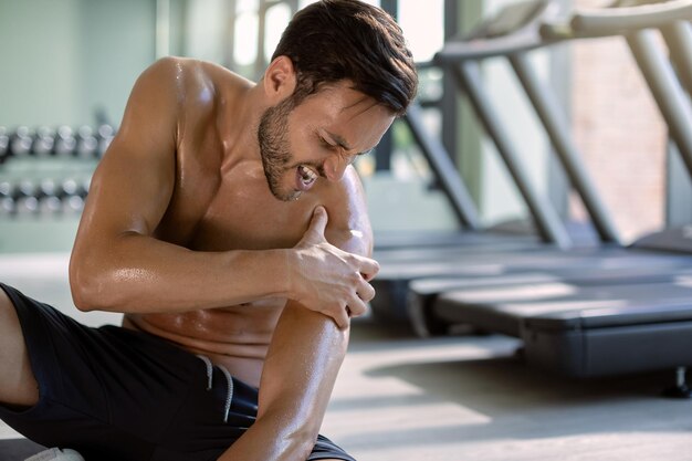 Männlicher Athlet verletzte sich beim Training im Fitnessstudio an der Schulter