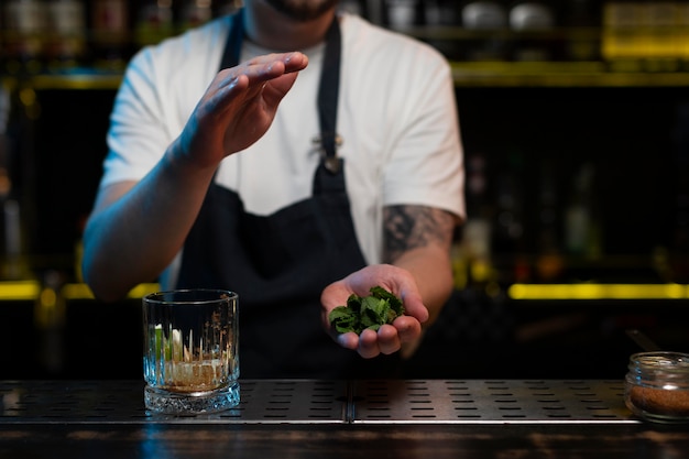 Kostenloses Foto männlicher barkeeper, der einen köstlichen cocktail macht