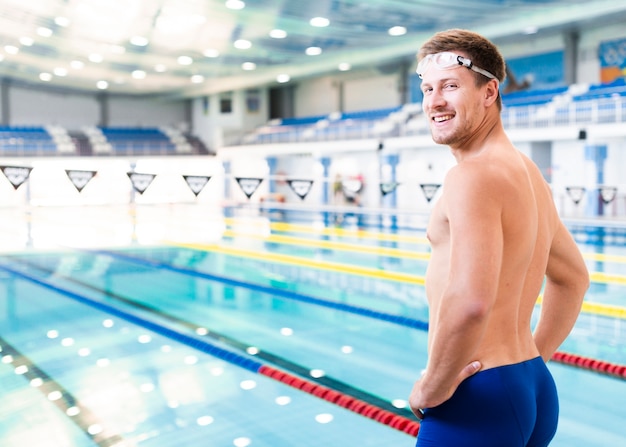 Männlicher Schwimmer der Seitenansicht am Pool