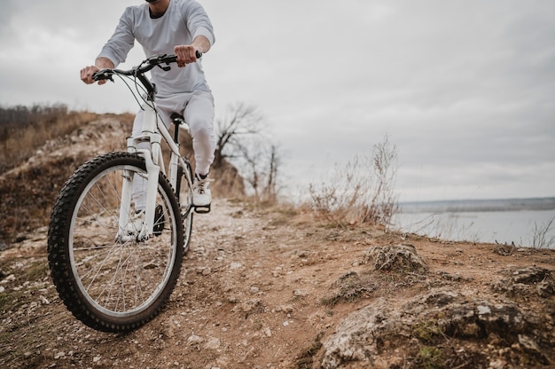 Mann, der ein Fahrrad draußen mit Kopienraum reitet