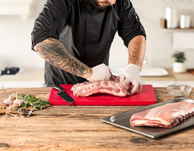 Mann, der Fleischsteak auf Küche kocht