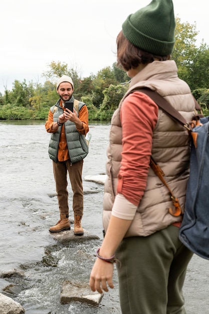 Kostenloses Foto mann, der fotos von freundin auf felsen macht