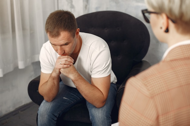 Mann, der im Büro des Psychologen sitzt und über Probleme spricht