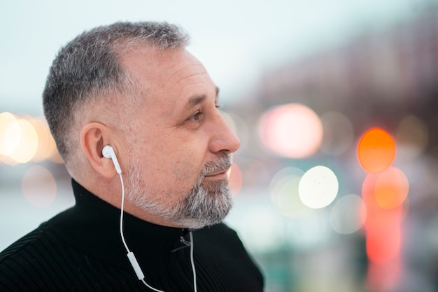 Kostenloses Foto mann, der musik draußen mit kopierraum hört