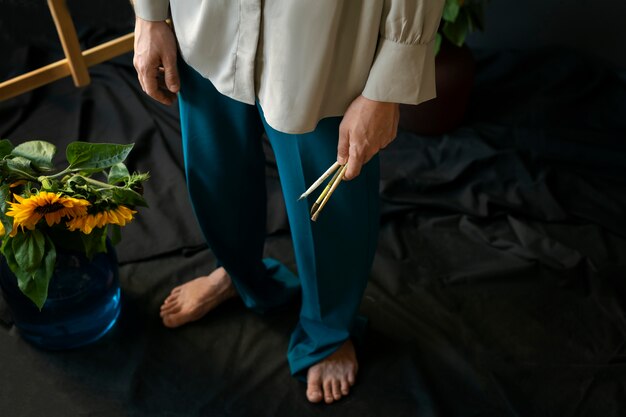Mann des hohen winkels, der mit sonnenblumen aufwirft