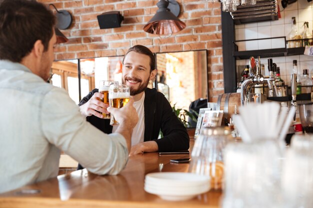 Mann mit Freund trinkt Bier in der Bar