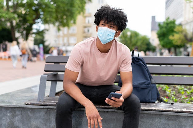 Kostenloses Foto mann mit gesichtsmaske im freien