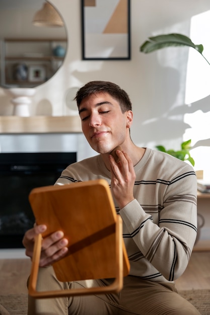 Kostenloses Foto mann schminkt sich drinnen