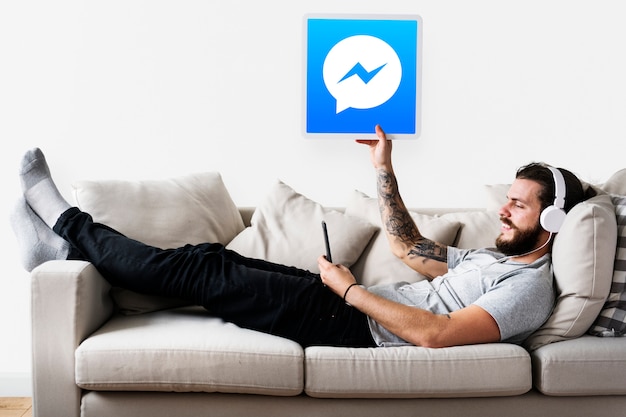 Mann zeigt ein Facebook Messenger-Symbol