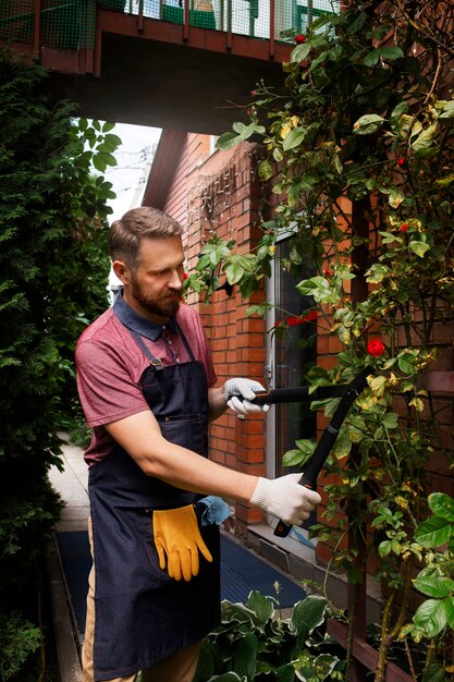 Manndiener, der sich um den Garten kümmert