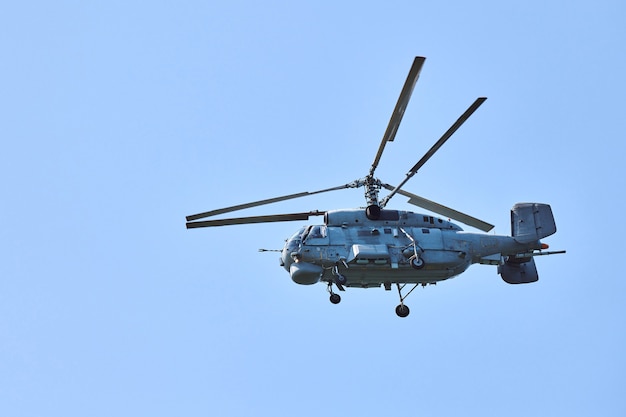 Marinehubschrauber, der gegen strahlend blauen himmelshintergrund fliegt, kopienraum. ein militärischer u-boot-abwehrhubschrauber, der die u-boot-suche demonstriert, seitenansicht