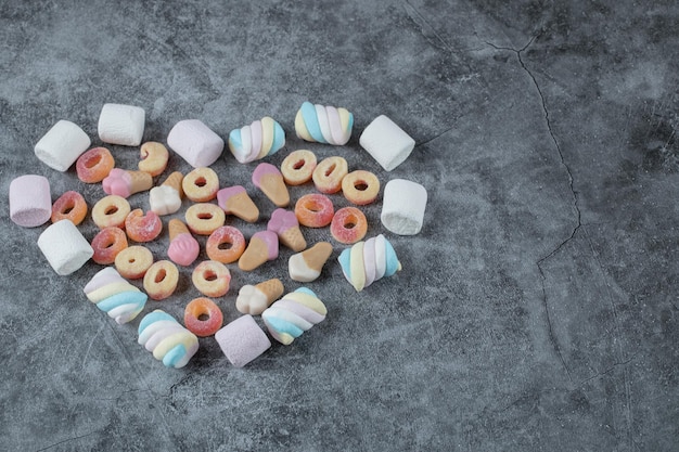 Kostenloses Foto marshmallow und jellybeans isoliert auf marmor.