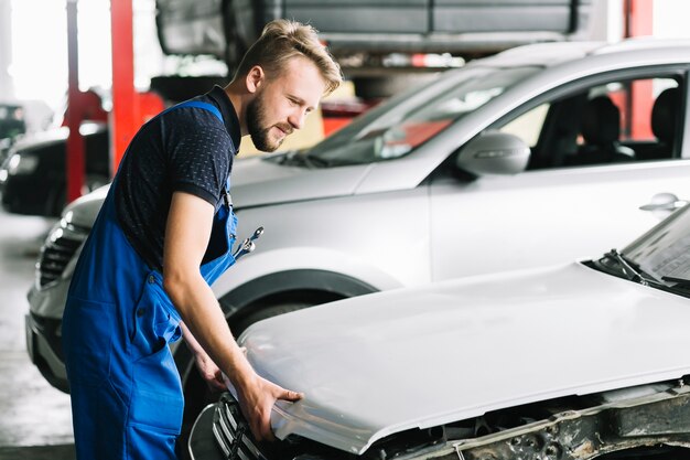 Mechaniker, der Autohaube öffnet