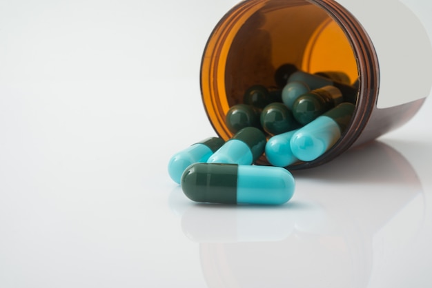 Medizinische pillen, die aus einem gestürzten tablettenfläschchen heraus verschüttet werden