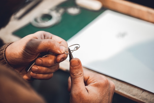 Kostenloses Foto meister mit metallfaden zur herstellung von schmuck