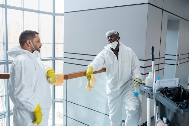 Menschen mit mittlerer Aufnahme, die Hazmat-Anzüge tragen