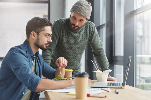 Mitarbeiter beim Mittagessen im Büro