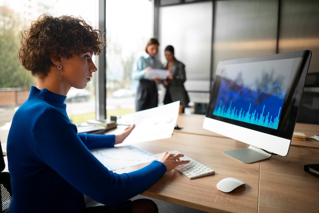 Kostenloses Foto mitarbeiter im büro analysieren und prüfen finanzdiagramme