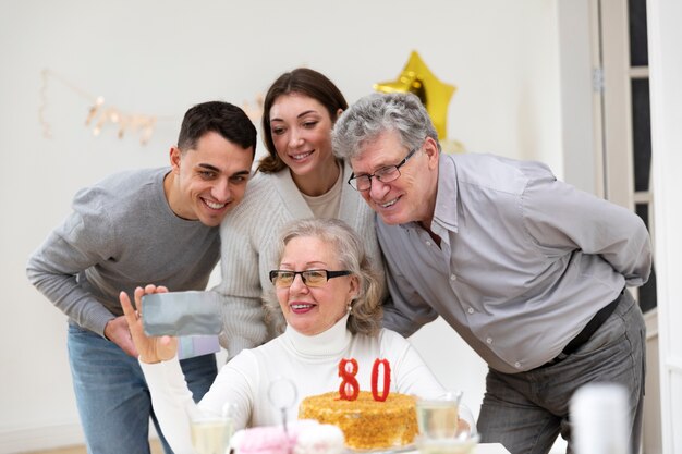 Mittelgroße Familie, die den Geburtstag einer Frau feiert