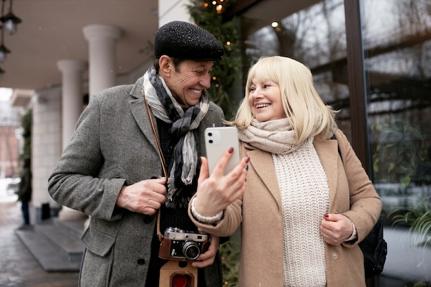 Kostenloses Foto mittelgroße smiley-leute mit smartphones