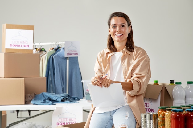 Kostenloses Foto mittelstarke smiley-frau mit spenden