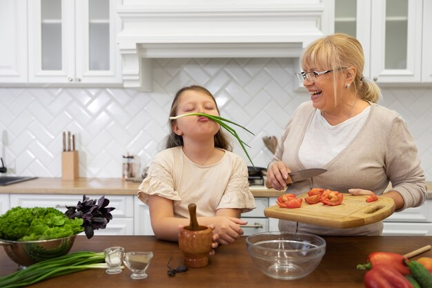 Mittlere geschossene Frau und Mädchen mit Essen