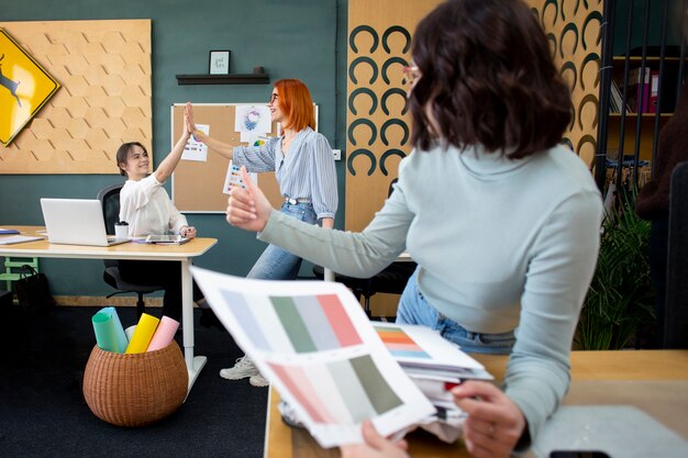 Mittlere Schussfrau, die mit Farbpaletten arbeitet