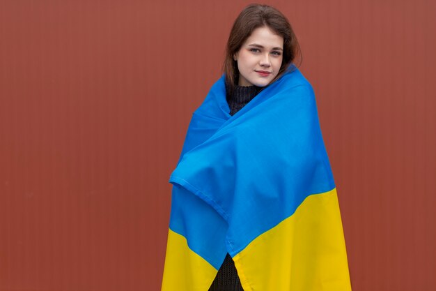 Mittlere Schussfrau, die ukrainische Flagge trägt