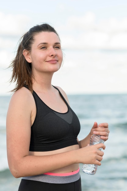 Mittlere Schussfrau, die Wasserflasche hält