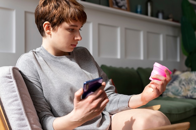 Mittlere Schussfrau, die wiederverwendbares Menstruationsprodukt hält