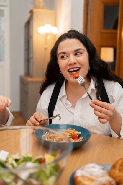 Kostenloses Foto mittlere schussfrau mit leckerem essen