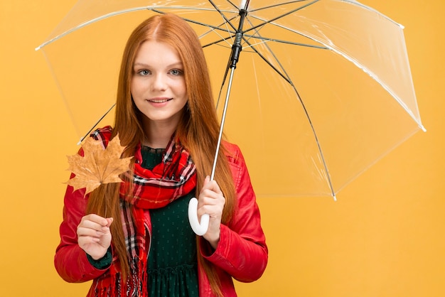 Kostenloses Foto mittlere schussfrau mit regenschirm und blatt