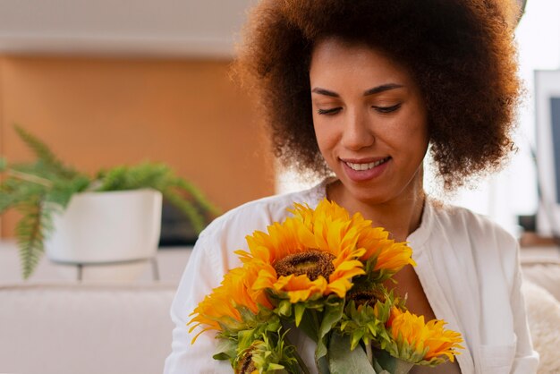 Kostenloses Foto mittlere schussfrau mit schönen sonnenblumen