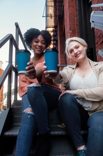 Mittlere Schussfrauen mit Tassen