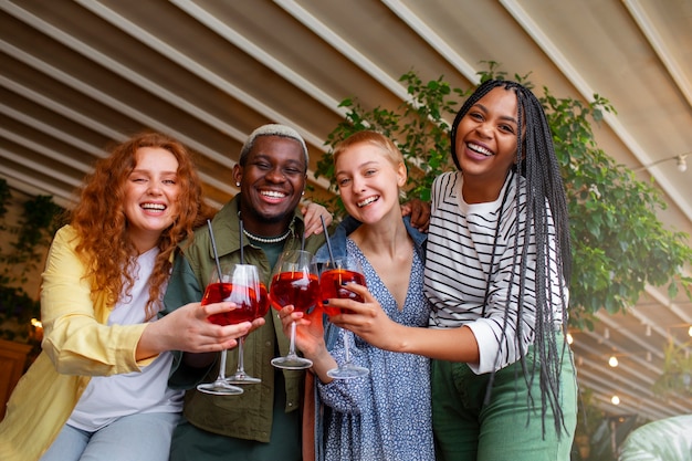 Kostenloses Foto mittlere schussfreunde, die cocktails trinken