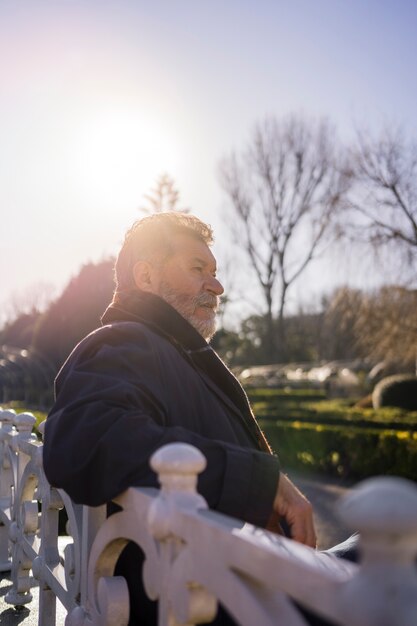 Mittlerer Schuss älterer Mann, der einen Spaziergang macht