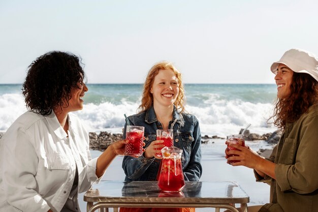 Mittlerer Schuss glückliche Freunde am Meer