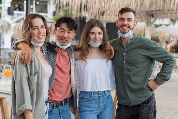 Mittlerer Schuss glückliche Freunde mit Masken