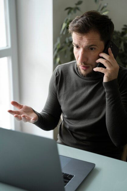 Mittlerer Schuss Mann, der am Telefon spricht