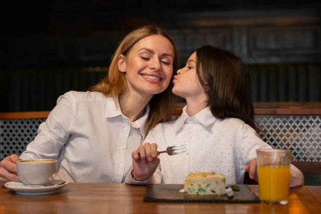 Mittleres Schussmädchen, das Frau küsst