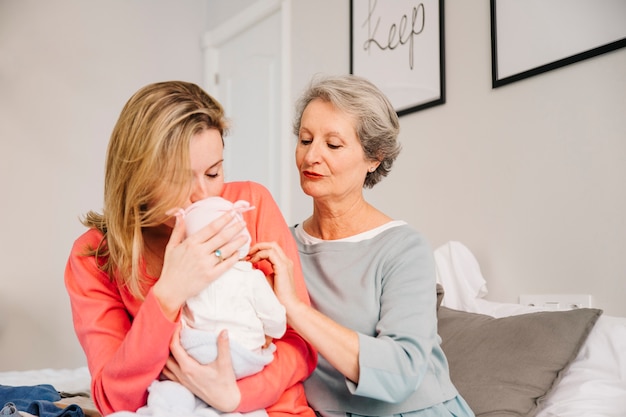 Kostenloses Foto mutter, die baby am muttertag hält