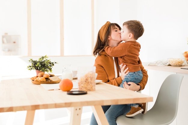 Kostenloses Foto mutter, die ihren sohn küsst