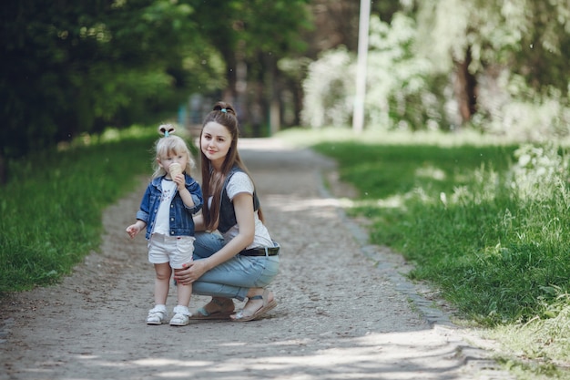 Mutter hockt mit ihrer Tochter, während ein Eis essen