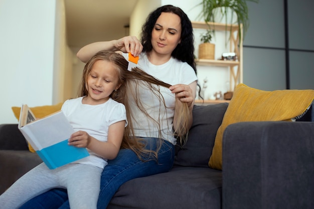 Mutter kümmert sich um Kind mit Kopfläusen