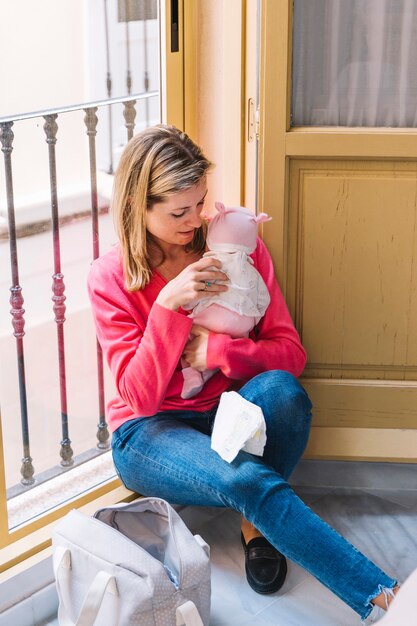 Mutter mit Baby vor Fenster