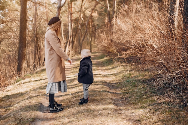 Mutter mit dem Sohn, der in einem Park spielt